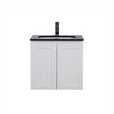White bathroom vanity with black countertop and faucet on a white background