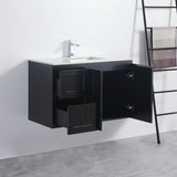 Black bathroom vanity with open cabinet doors on a white wall.