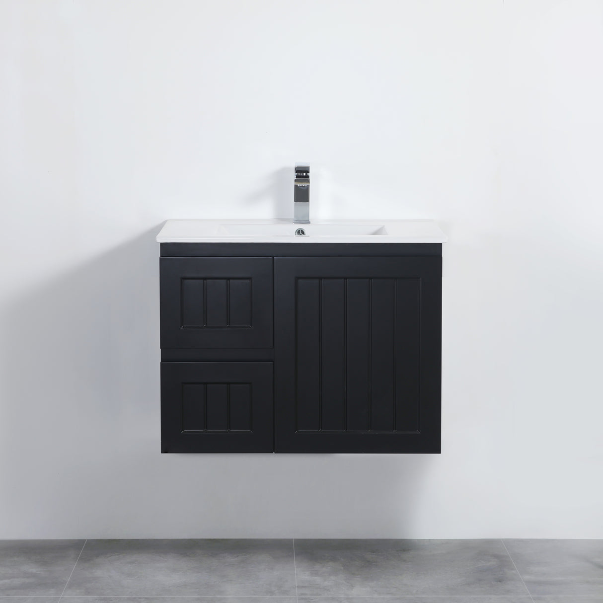 Black bathroom vanity with white countertop against a white wall.