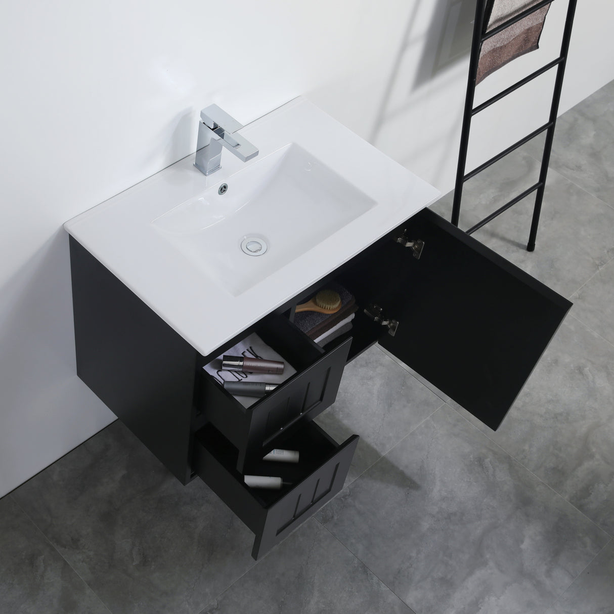 Bathroom vanity with open drawer, sink, and ladder against a white wall.
