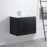 Black bathroom vanity with white sink against a white wall.