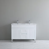 White bathroom vanity with two sinks against a gray wall.
