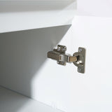 Close-up of a cabinet hinge on a white cabinet