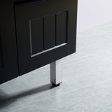 Dark wooden cabinet with a metal leg on a light gray floor