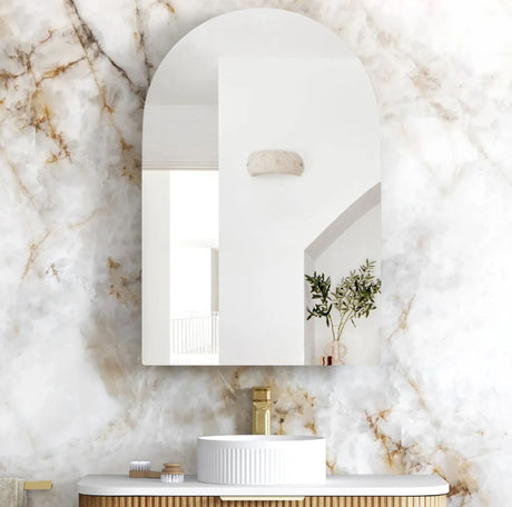 Bathroom with marble walls, a sink, and decorative elements.