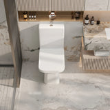 Modern bathroom with a white toilet and marble walls.