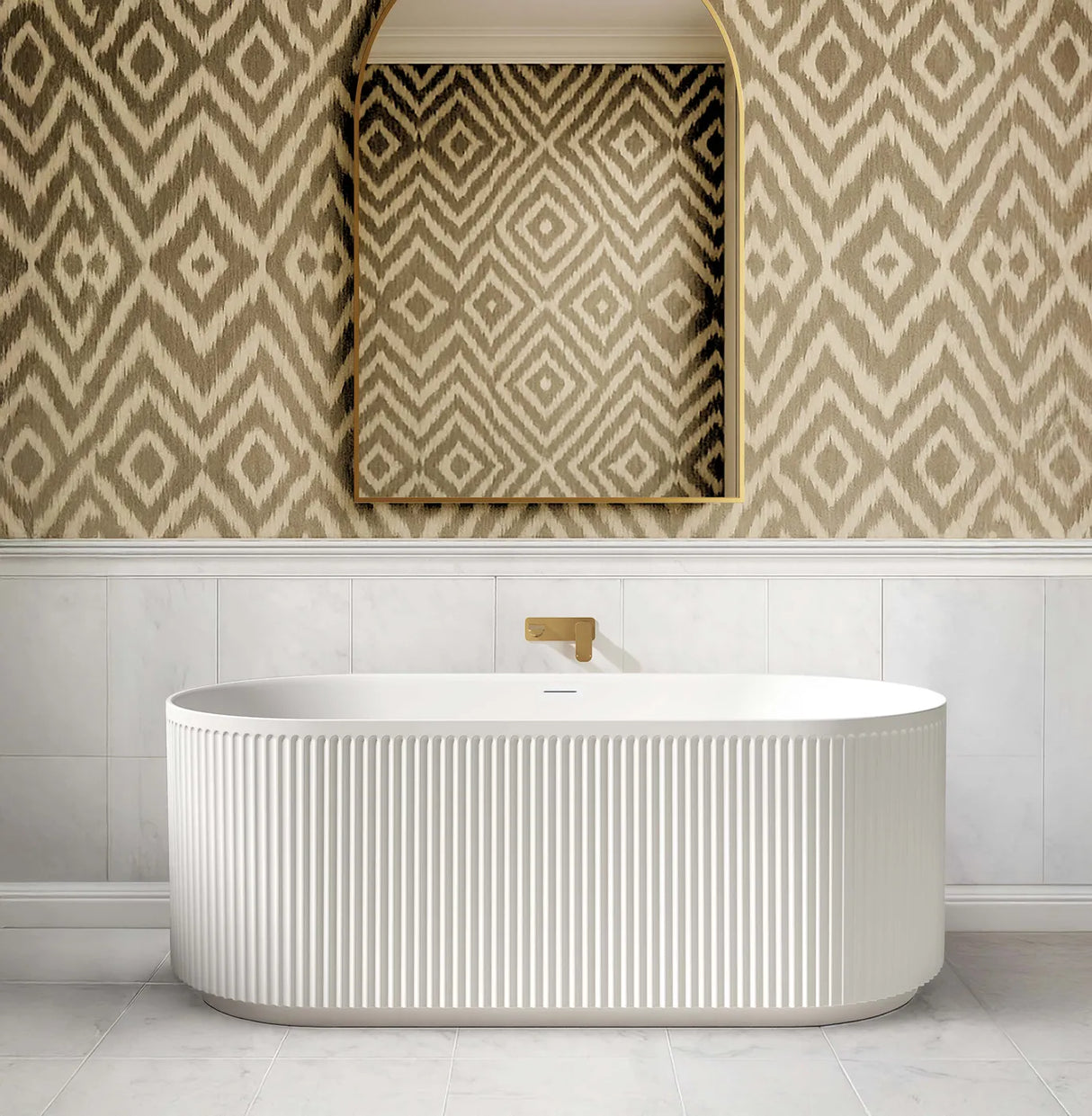 Modern freestanding bathtub in a bathroom with patterned wallpaper and mirror.