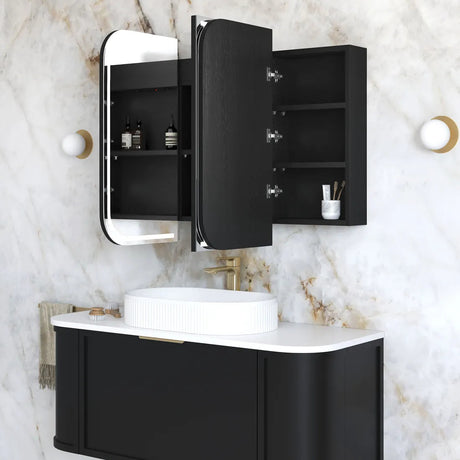 Bathroom setup with black vanity unit, mirror, and sink on a marble wall.