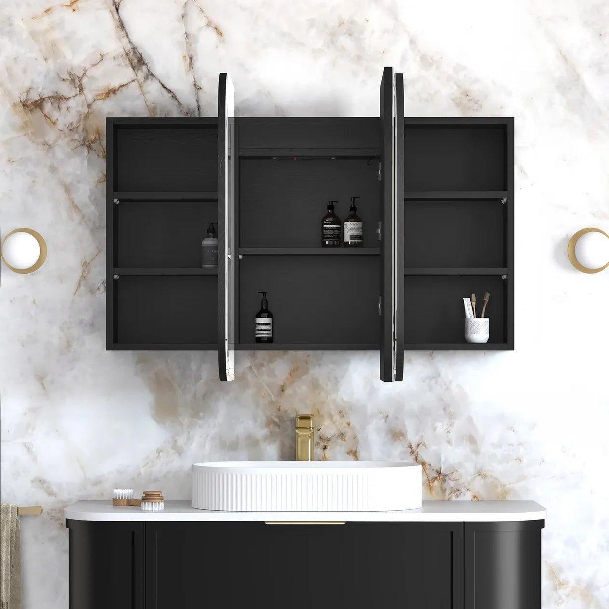 Bathroom setup with black wall-mounted cabinet, white sink, and marble wall.