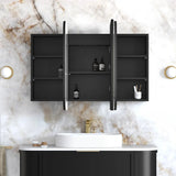 Bathroom setup with black wall-mounted cabinet, white sink, and marble wall.