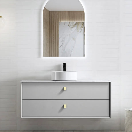 Bathroom vanity with mirror and sink on a light gray wall.
