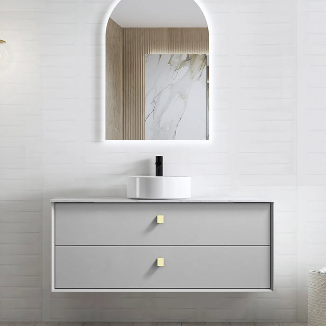 Bathroom vanity with mirror and sink on a light gray wall.