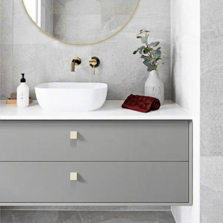 Bathroom vanity with round mirror, sink, and decorative elements.