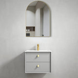 Bathroom vanity with two drawers and a mirror on a gray wall.