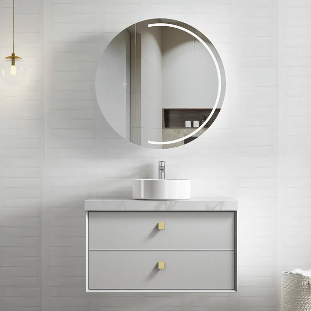 Bathroom vanity with round mirror and light fixture on a neutral wall.