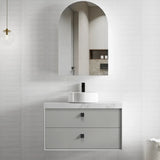 Bathroom vanity with marble countertop and arch-shaped mirror