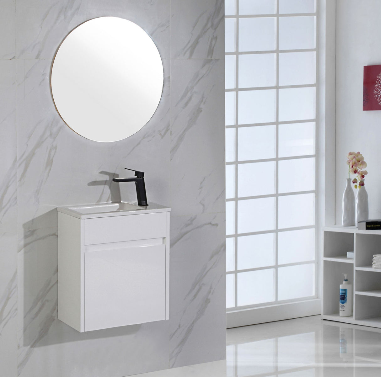 Bathroom with white vanity unit, round mirror, and window