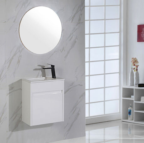 Bathroom with white vanity unit, round mirror, and window