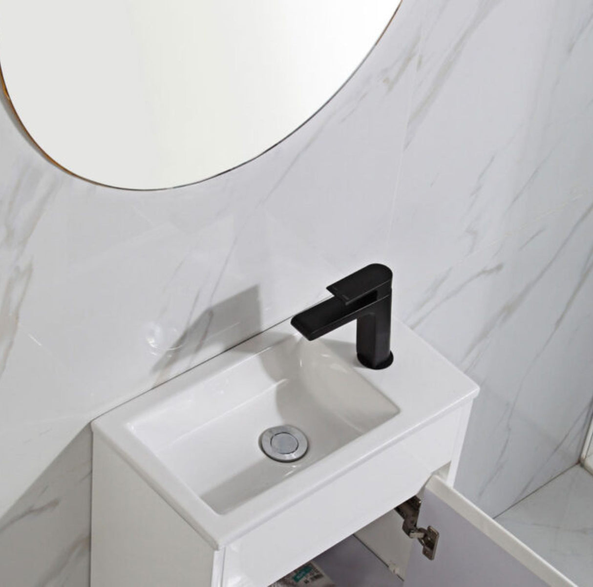 White sink with black faucet in a bathroom setting