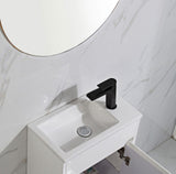 White sink with black faucet in a bathroom setting
