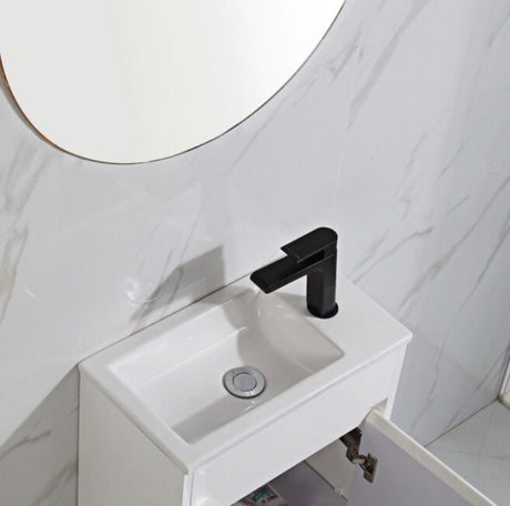 White sink with black faucet in a bathroom setting