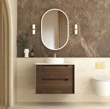 Bathroom vanity with wooden cabinet, round mirror, and decorative elements.