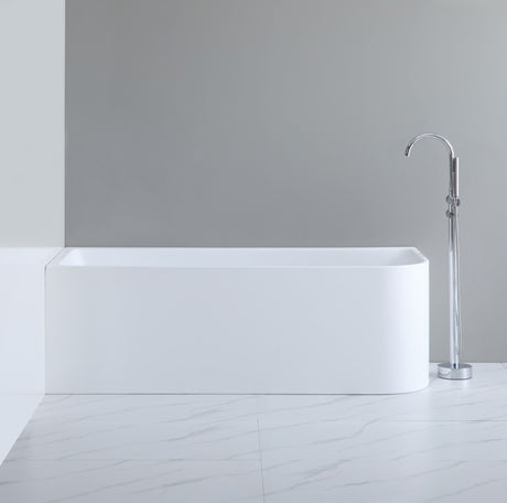 Modern freestanding bathtub in a minimalistic bathroom setting with a gray wall and white floor.