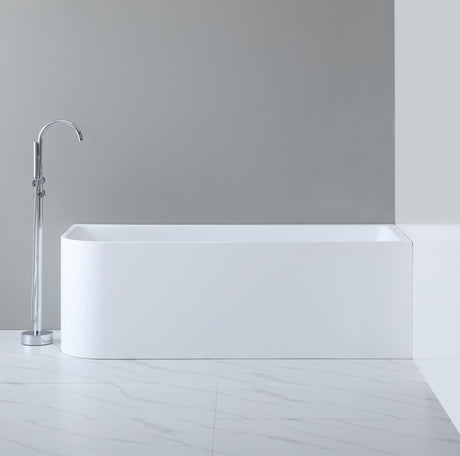 Modern freestanding bathtub in a minimalistic bathroom setting with a gray wall and white floor.