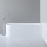 Modern freestanding bathtub in a minimalistic bathroom setting with a gray wall and white floor.