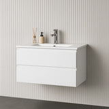 White wall-mounted vanity with sink and faucet against a striped wall.