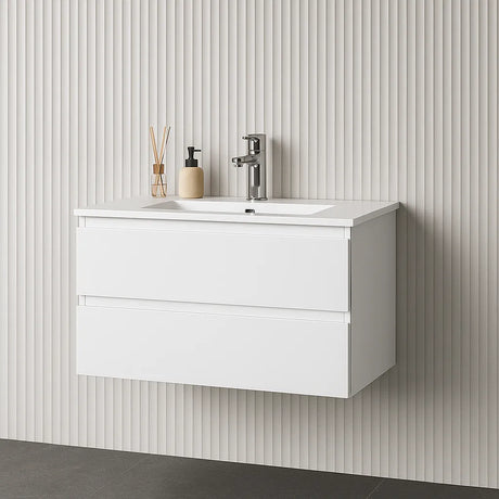 White wall-mounted vanity with sink and faucet against a striped wall.
