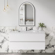 Bathroom vanity with marble wall and arch mirror
