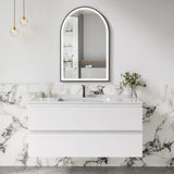 Bathroom vanity with marble wall and arch mirror