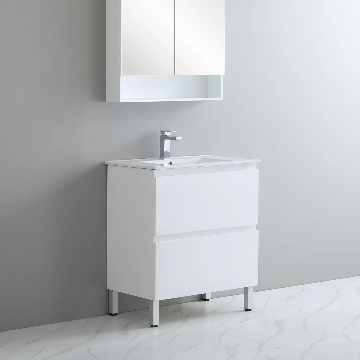 Bathroom vanity with sink and mirror cabinet against a gray wall.