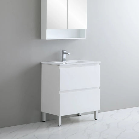 Bathroom vanity with sink and mirror cabinet against a gray wall.