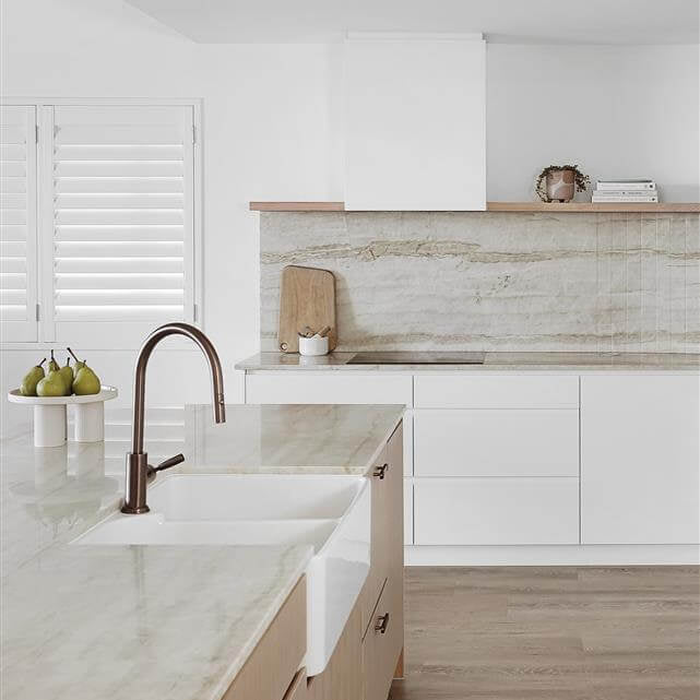 Modern kitchen with marble countertops and white cabinets