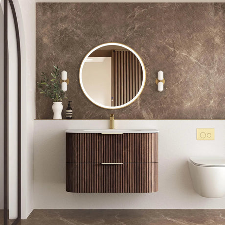 Bathroom with wooden vanity, round mirror, and decorative elements.
