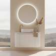 Bathroom vanity with round mirror and decorative elements against a scenic window backdrop