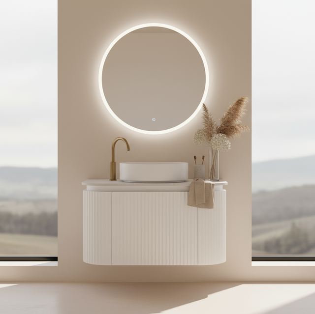 Bathroom vanity with round mirror and decorative elements against a scenic window backdrop
