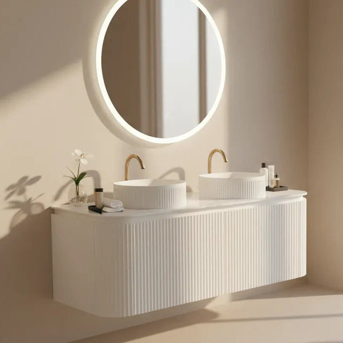 Modern bathroom with a white vanity and round mirror