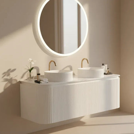 Modern bathroom with a white vanity and round mirror