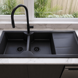 Black kitchen sink with a modern faucet in a well-lit kitchen.