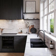 Modern kitchen with black appliances and marble countertops