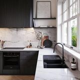 Modern kitchen with black appliances and marble countertops