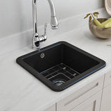 Black kitchen sink with silver faucet on a white countertop
