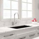 Modern kitchen with marble countertops, a sink, and decorative elements.