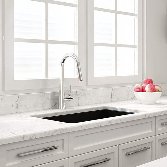 Modern kitchen with marble countertops, a sink, and decorative elements.