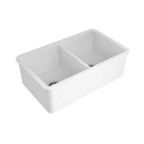 A white double-bowl farmhouse kitchen sink with a deep rectangular basin and a central divider, shown on a plain white background.
