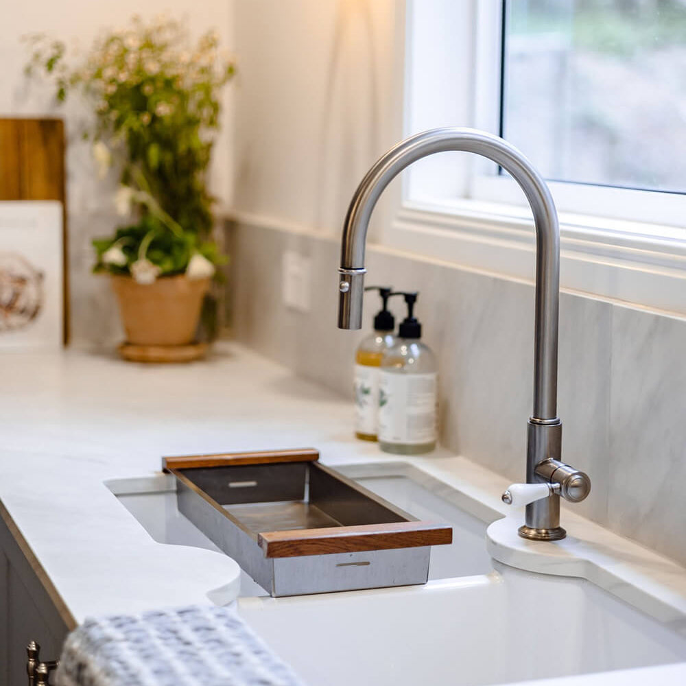 Modern kitchen sink with a faucet and window in the background