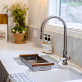 Modern kitchen sink with a faucet and window in the background